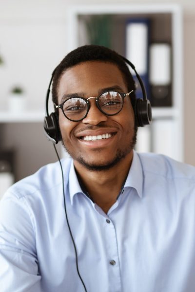 happy-black-consultant-with-headset-waving-at-camera.jpg